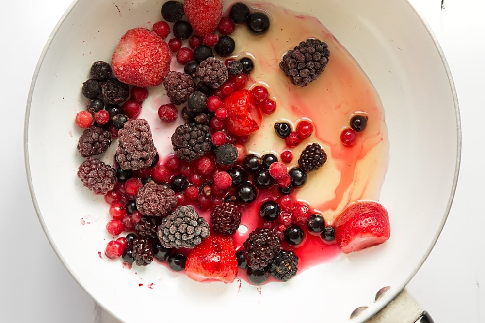 Making homemade berry sauce to serve with the matcha pancakes