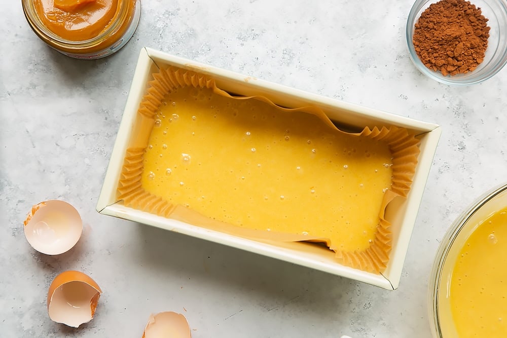 Pour half the cake mixture into a cake loaf tin