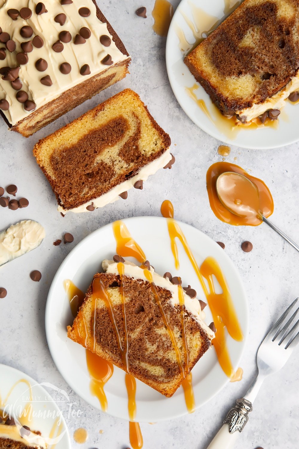 Chocolate marble cake with a salted caramel cream cheese frosting, shown drizzled with warmed caramel sauce