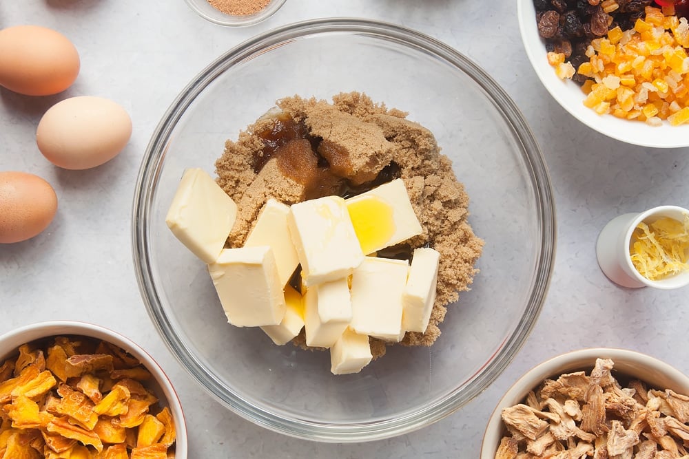 To start with the Tropical fruit cake you're going to want to put cubes of butter into a bowl.