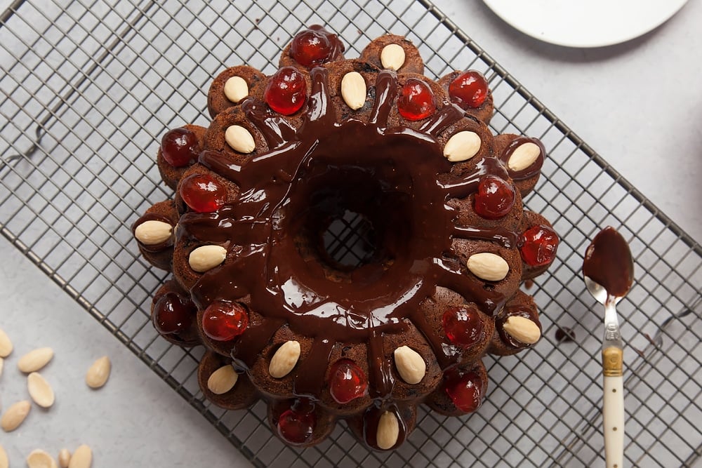 Decorating the Tropical fruit cake with cherries and almonds