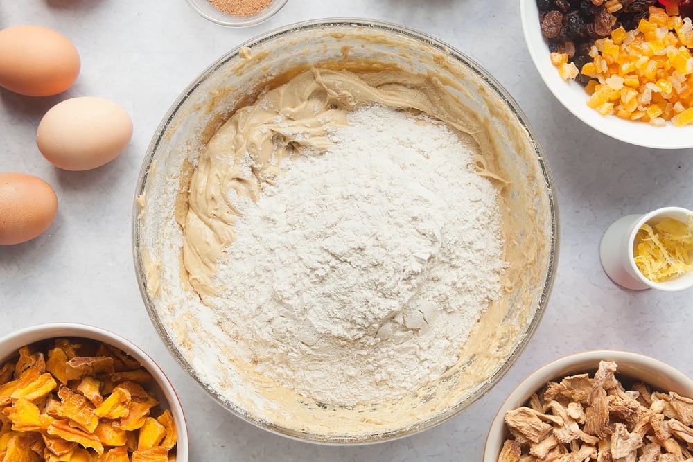 Additional flour being added to the Tropical fruit cake mix