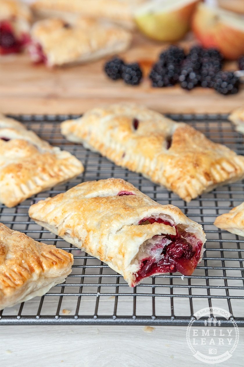 Apple and blackberry pie with puff pastry cut open on a wire rack