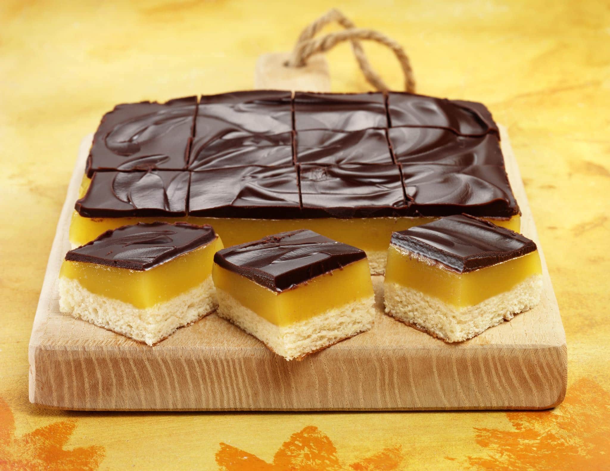 Chocolate orange jelly squares! A zingy treat incorporating a sponge layer, an orange jelly layer and an indulgent layer of dark chocolate to finish!.