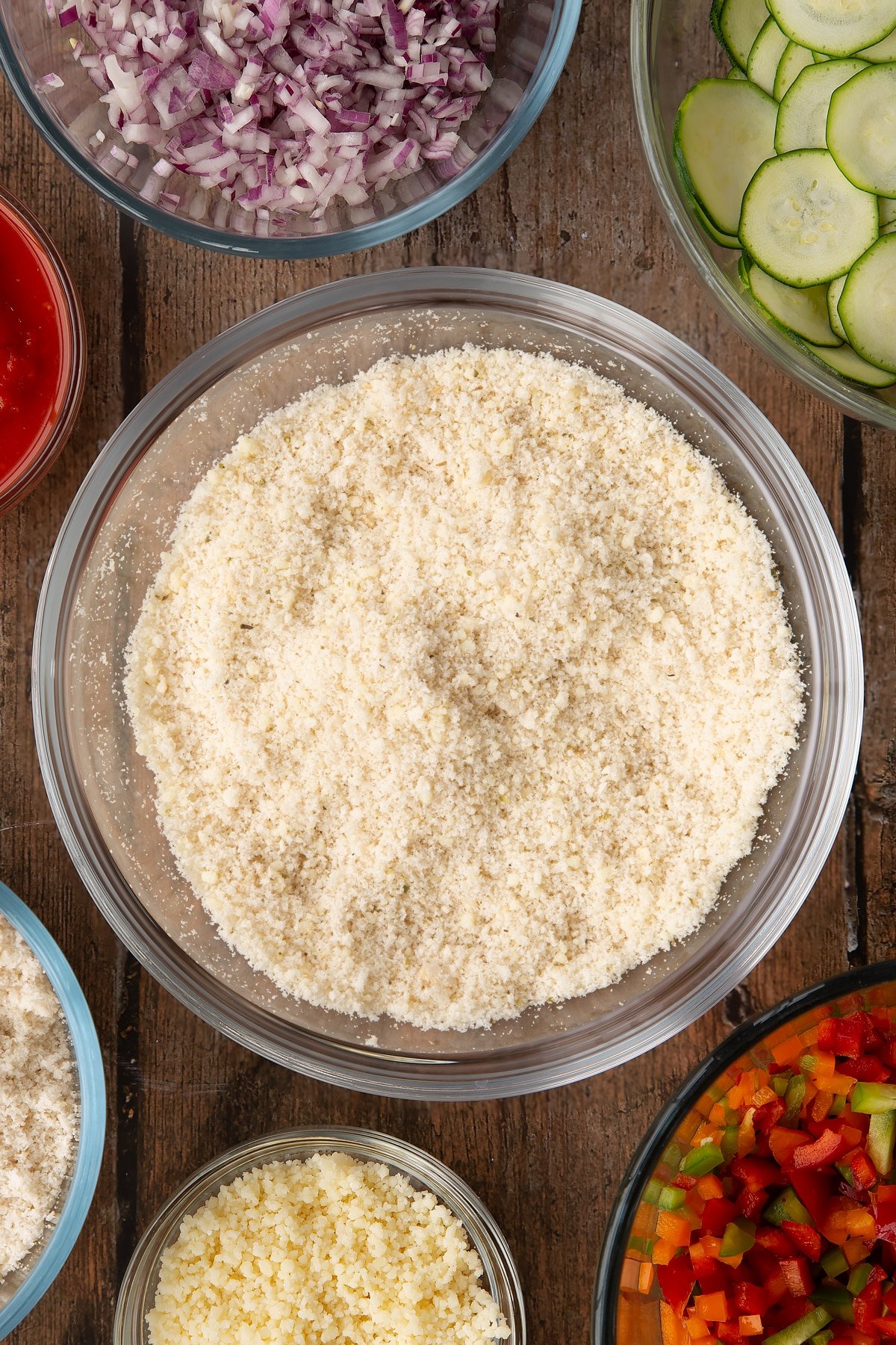 mixed fresh breadcrumbs, dried oregano, and parmesan in a large clear bowl.