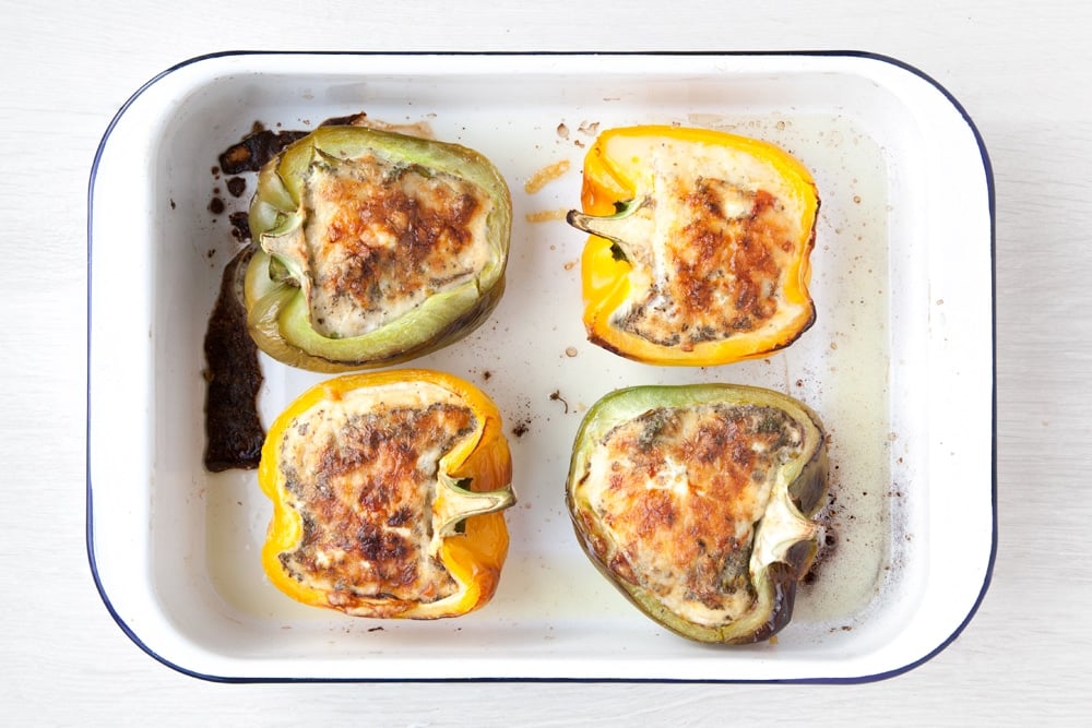 The baked pepper quiches cups in a baking pan having been in the oven.