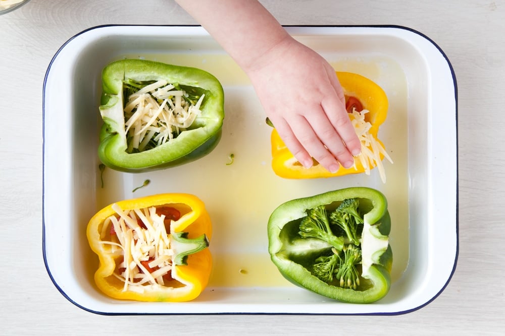 Topping the pepper cups with grated cheese