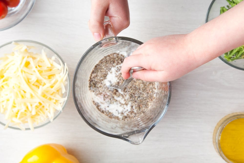 Whisking the quiche mix in a jug.