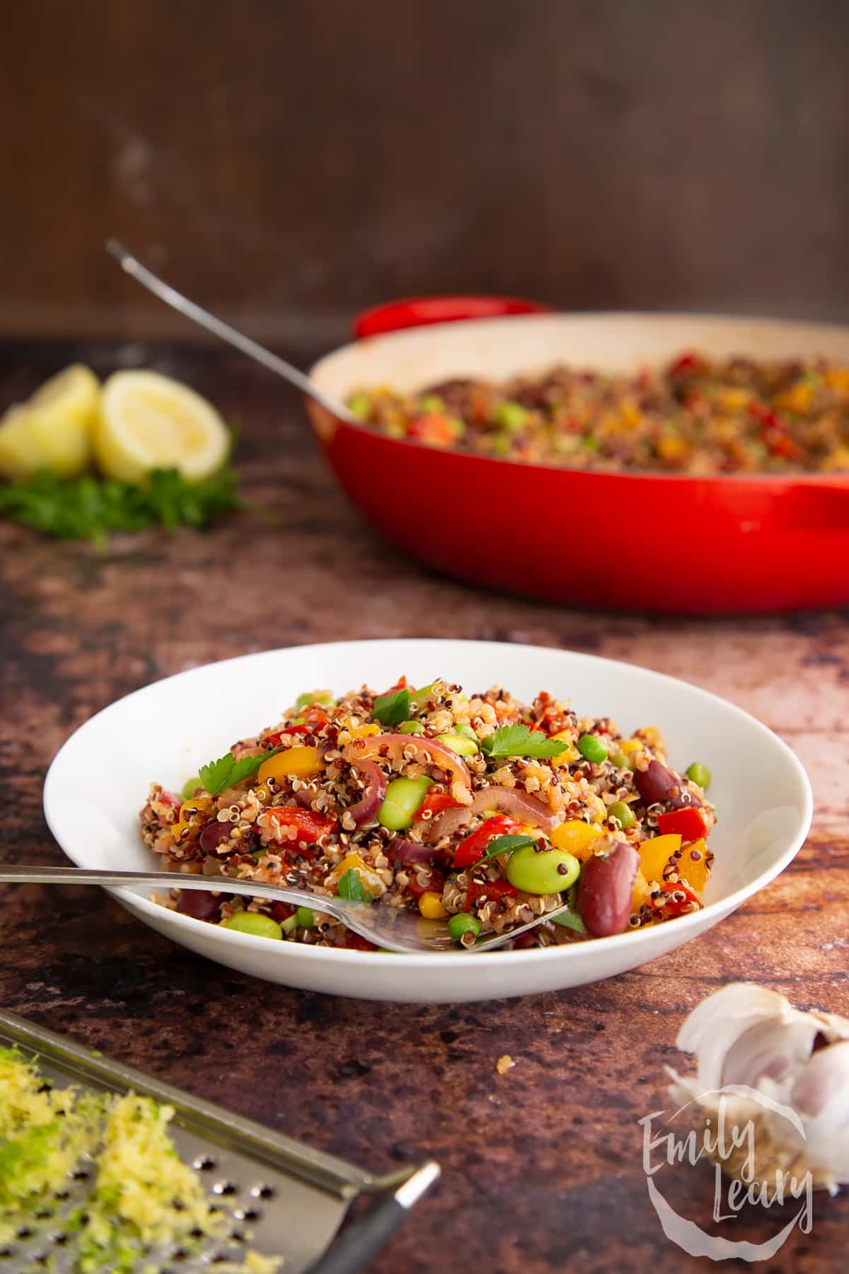 A finished bowl of Zesty bean quinoa sitting on a wooden table.