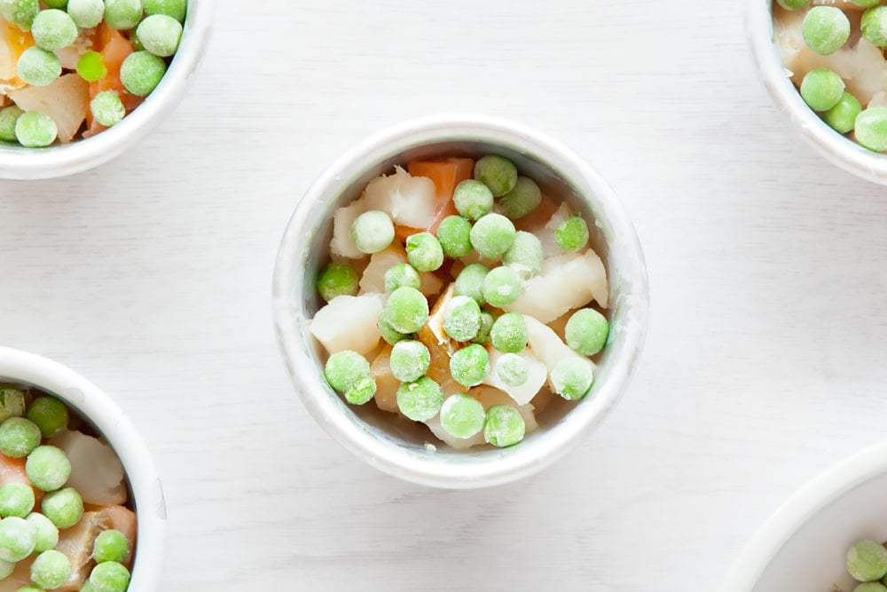 Top the fish pie mix with peas