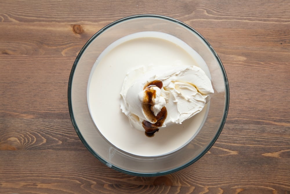 A bowl containing cream cheese, double cream and vanilla. 