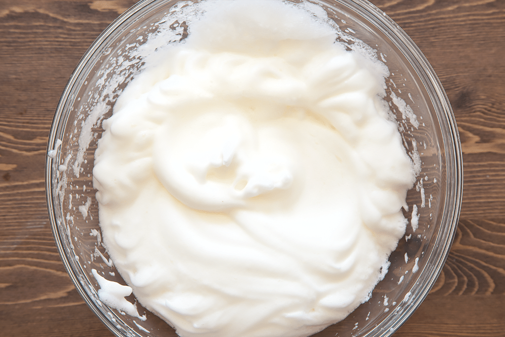 Whisked egg whites in a bowl