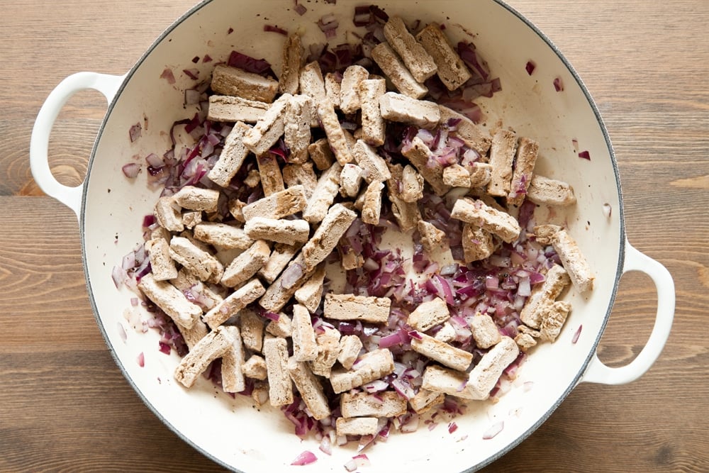 Adding the Quorn meat free steak strips to the pan