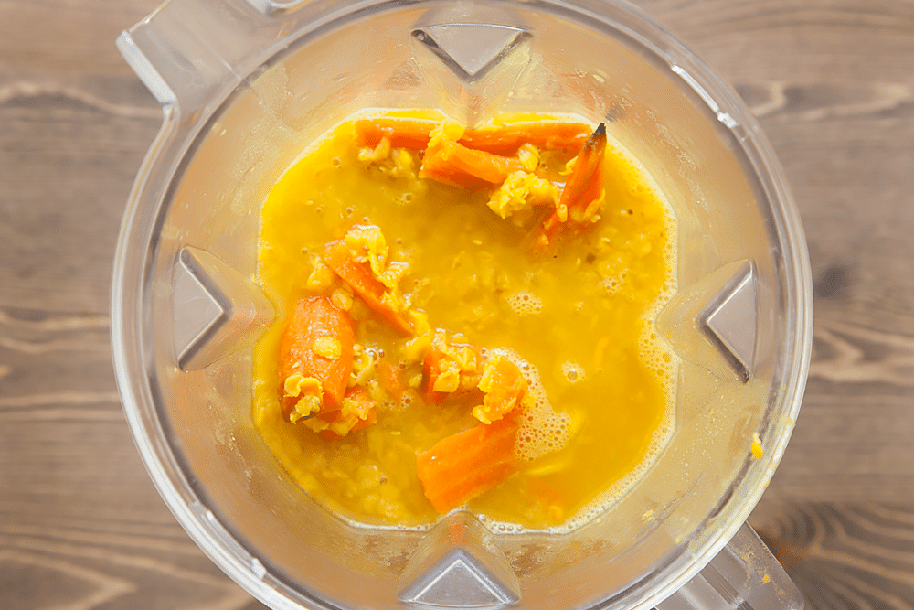Blending the ingredients for carrot and orange soup together