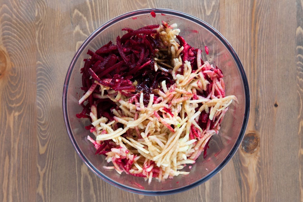 Grated bramley apples and beetroot in a bowl