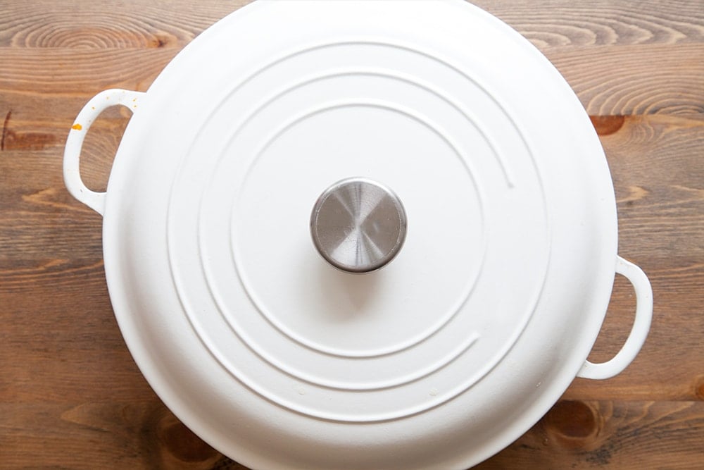 Overhead shot of a white casserole dish on a wooden surface