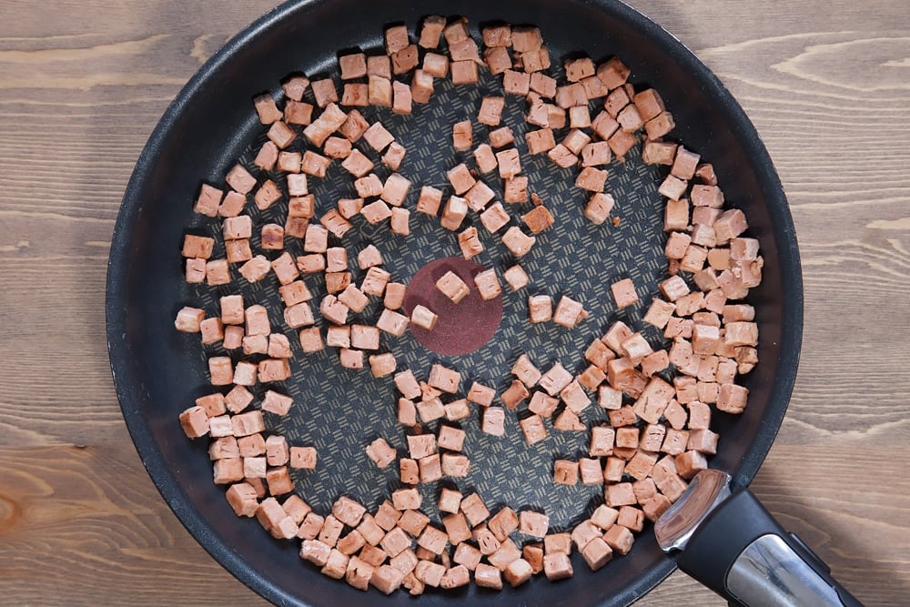 cooked Quorn meat free bacon lardons in a frying pan 