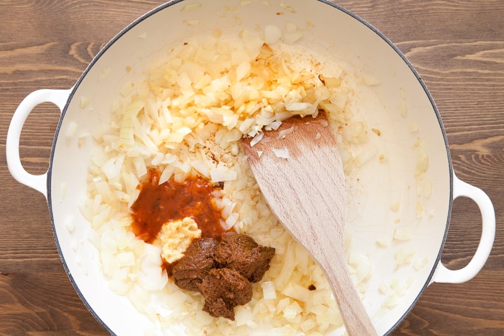 Mixing in hot chilli sauce, curry paste and ginger