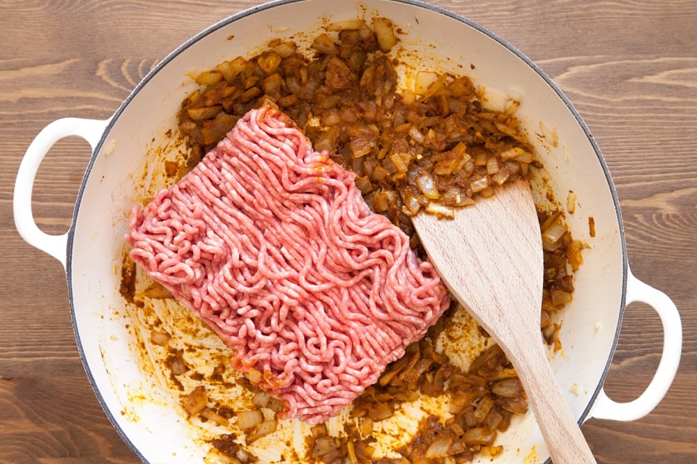 Adding lamb mince to the frying pan