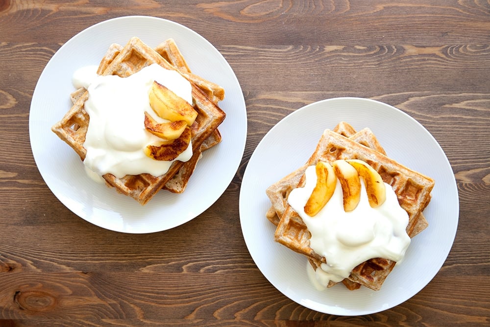 Serve your granola waffles stacked and topped with natural yogurt and sliced apple