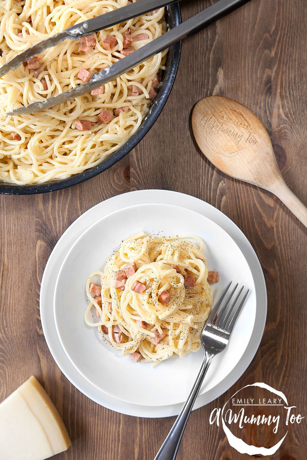 meat-free spaghetti carbonara on a white plate next to the pan of spaghetti carbonara