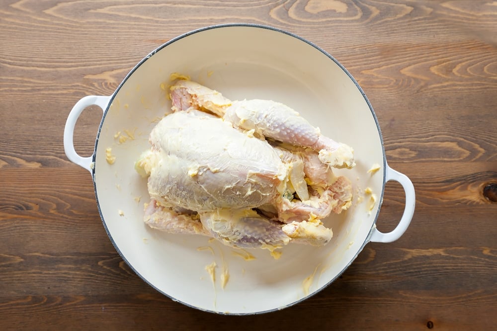 Chicken slathered in butter, ready to be roasted