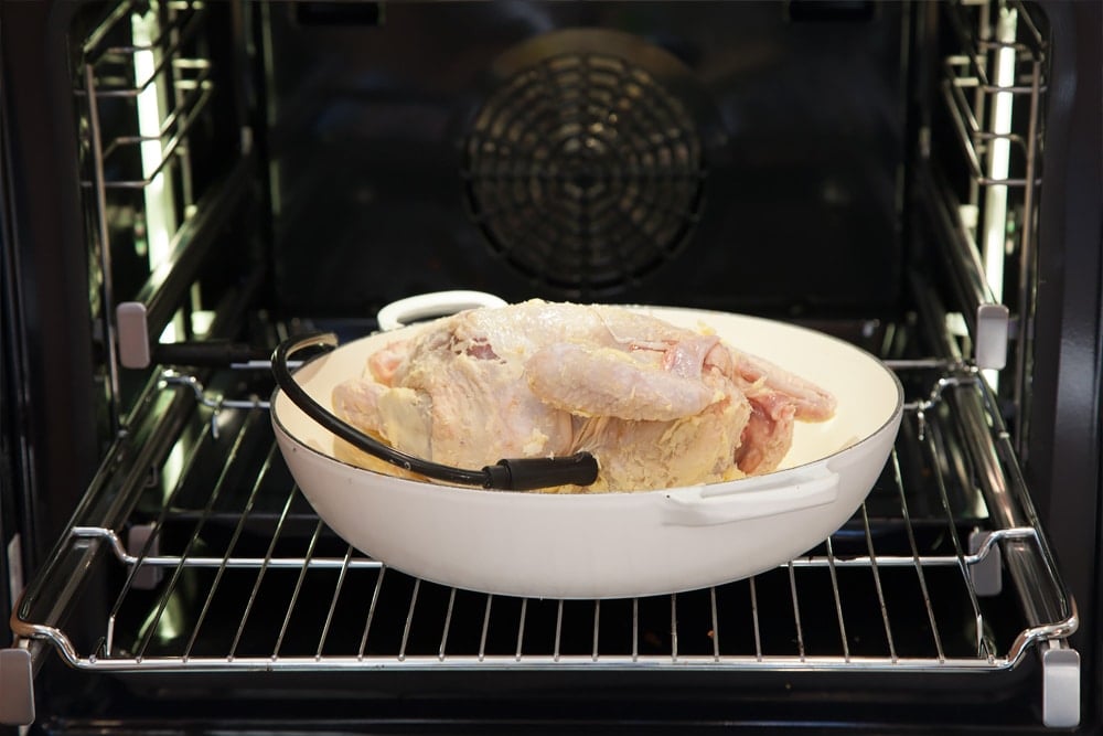 Sage and onion roast chicken in an oven