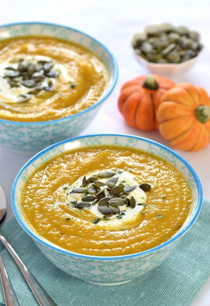 curried pumpkin & parsnip soup in a colourful blue print bowl on a blue folded napkin