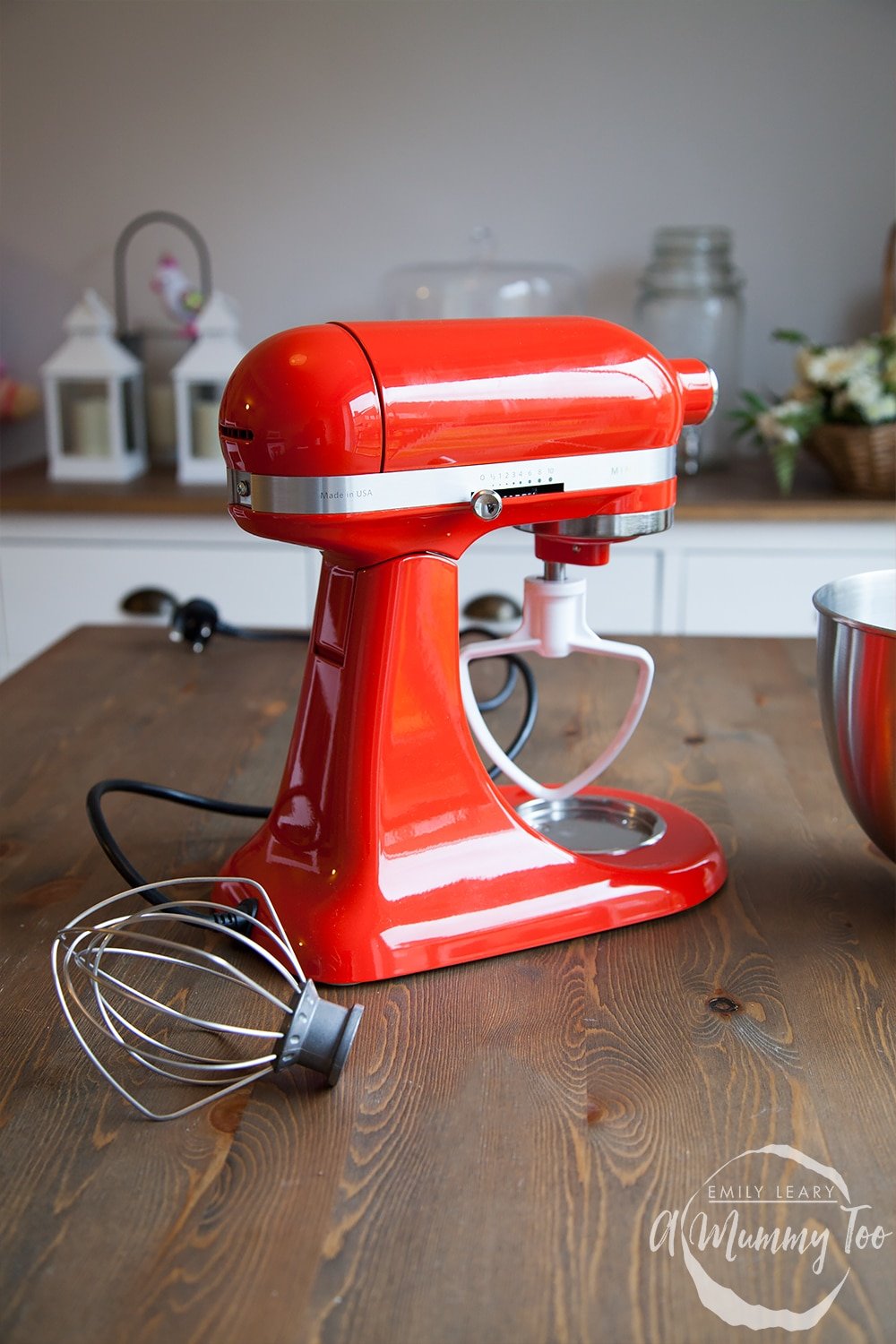 Close up of the back of the red KitchenAid Mini on a wooden countertop. 