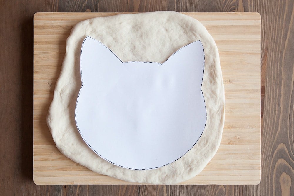 Use the free downloadable cutout to create the perfect kitty shaped pizza