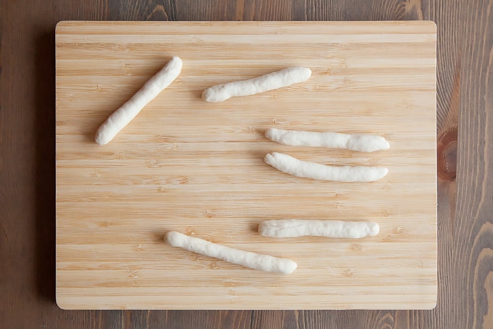 The remaining dough is used to create breadstick whiskers