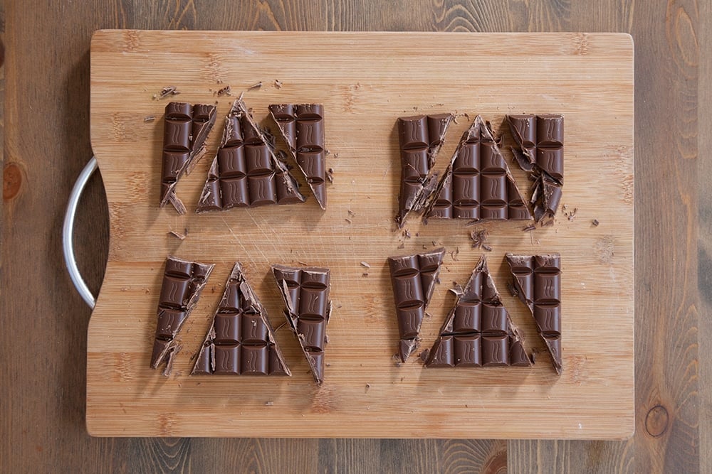 Cutting chocolate bars into triangles to create the pastry fillings