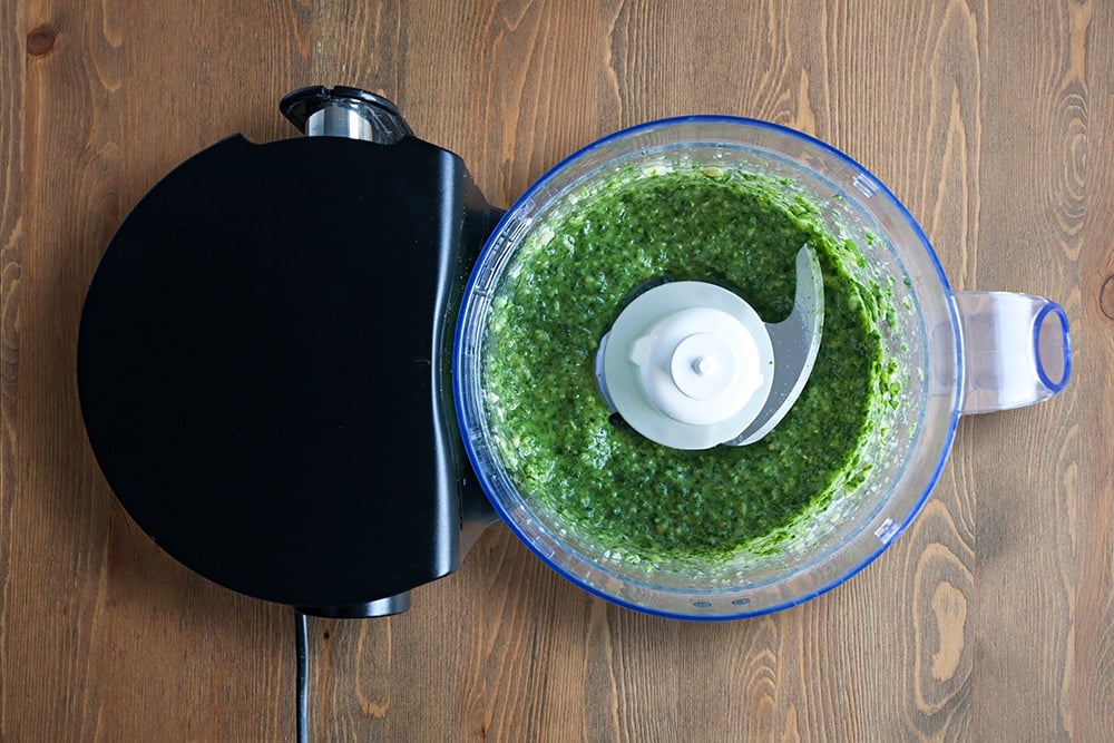 Blitzing the ingredients together to make pesto