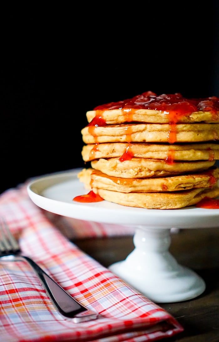 Peanut Butter and Jelly Pancakes by the love nerds stacked on a white plate.