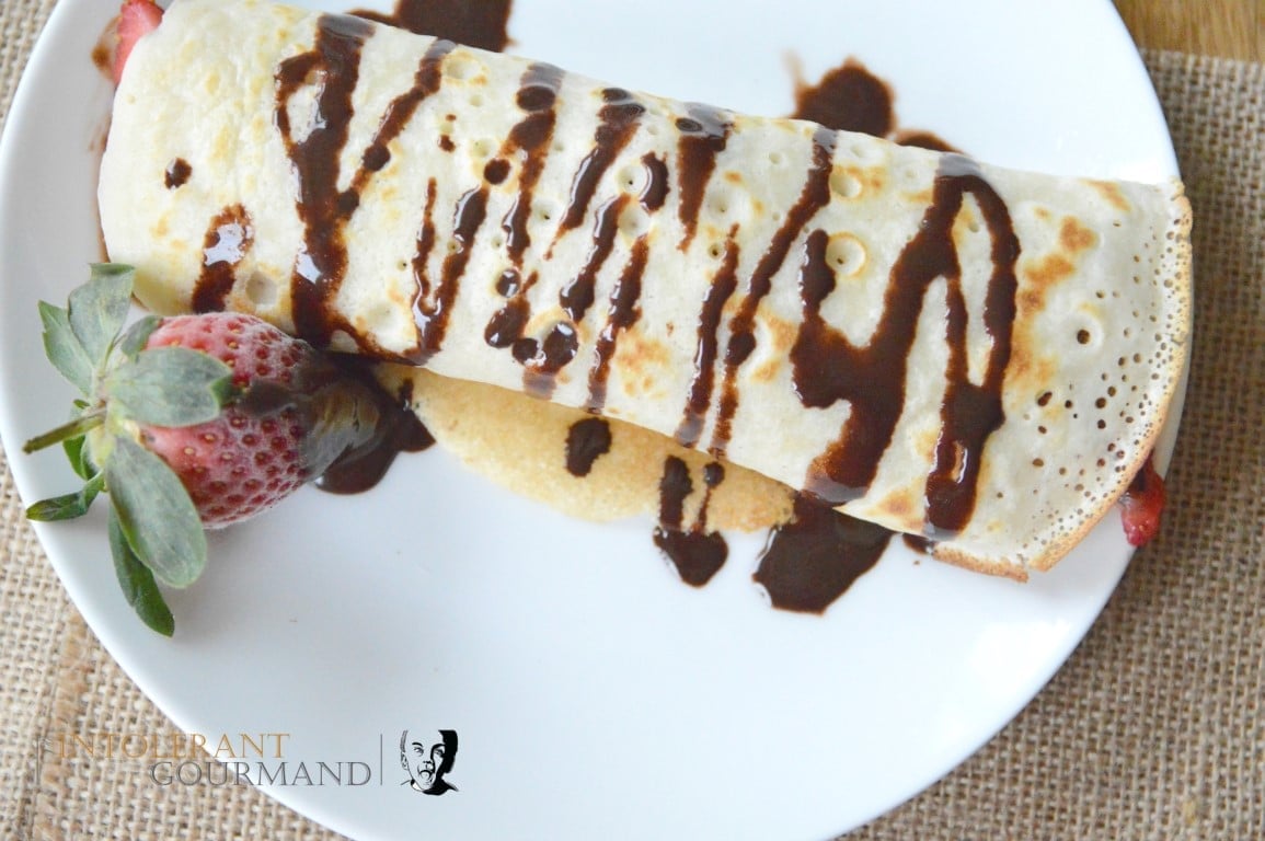 Perfect Free From Pancakes by intolerant gourmand on a white plate accompanies by a strawberry