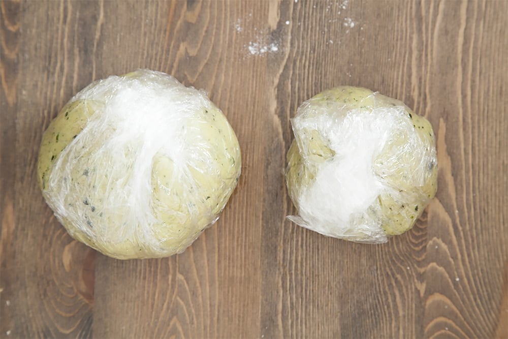 The pastry balls are wrapped and set aside while preparing the layered vegetable pie filling