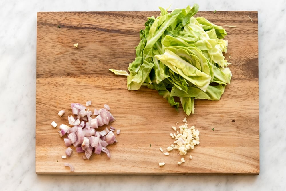 Preparing the spring greens and onion for the dish