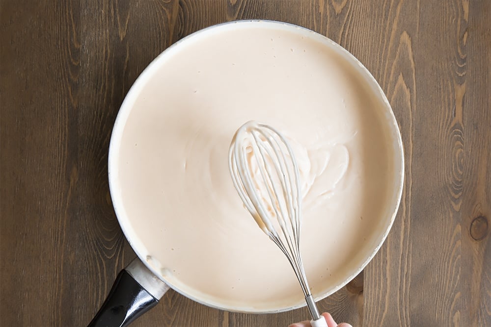 Preparing the custard "cheese sauce" in a pan