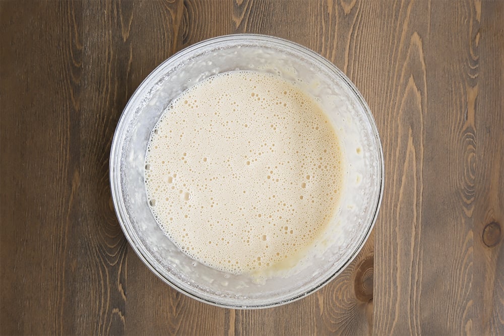 Whisked eggs, flour, sugar, vanilla essence and splash of the milk in a large bowl.