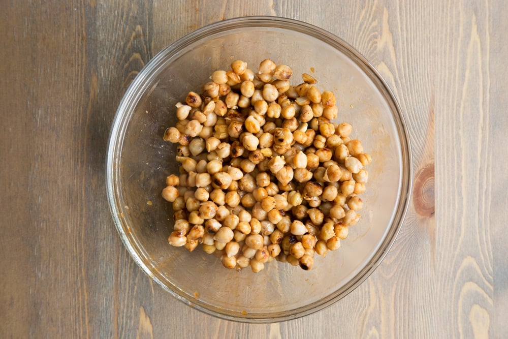 Cooked BBQ chickpeas, shown in a glass bowl, ready for you to continue preparing your summer BBQ wraps