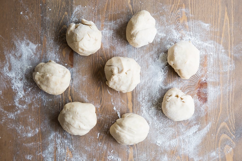 Tortilla dough rolled into eight balls, ready to be rolled out