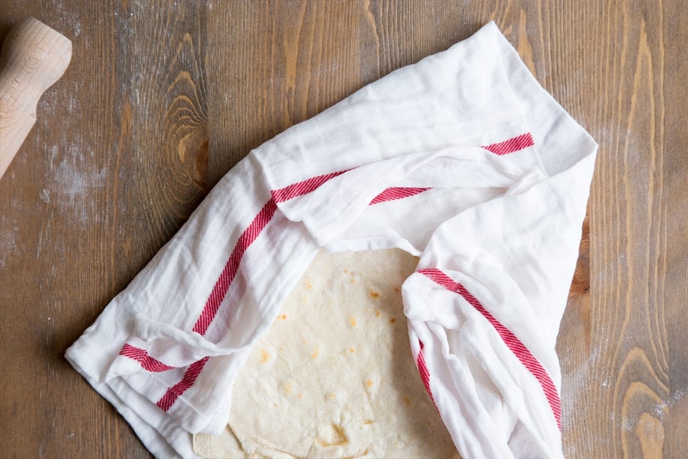 Cooked tortillas wrapped in a damp tea cloth, to keep them soft while you prepare your BBQ chickpeas