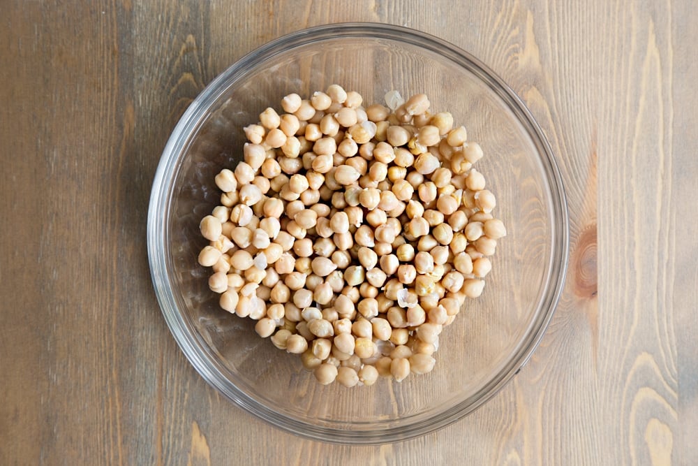 Rinsed and drained chickpeas, shown in a glass bowl