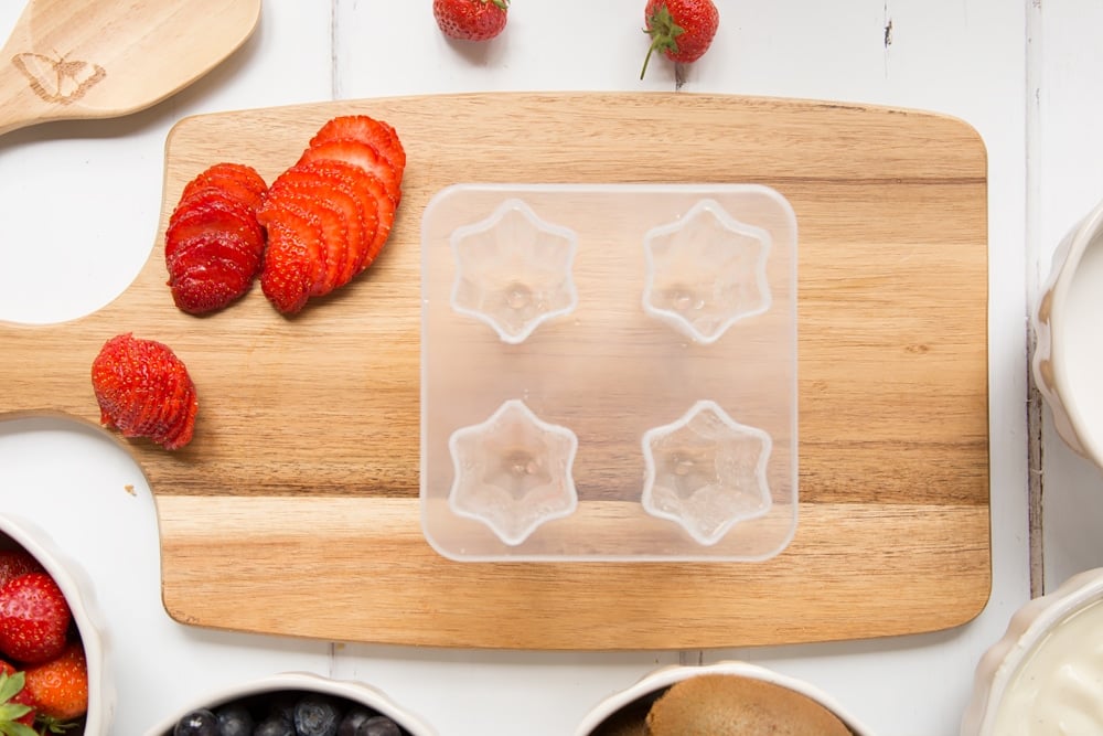 Prepare your sliced fruit, ready to add to the ice lolly moulds