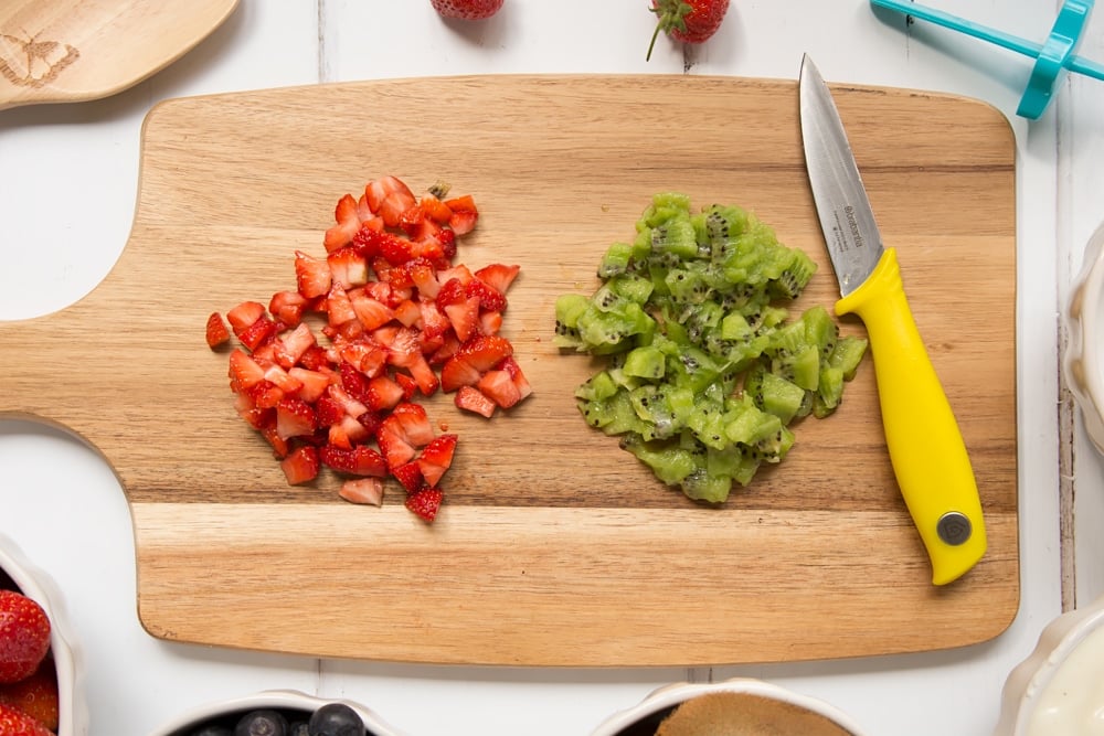 Chopped strawberries and kiwi, ready to be added to your yogurt lolly mixture