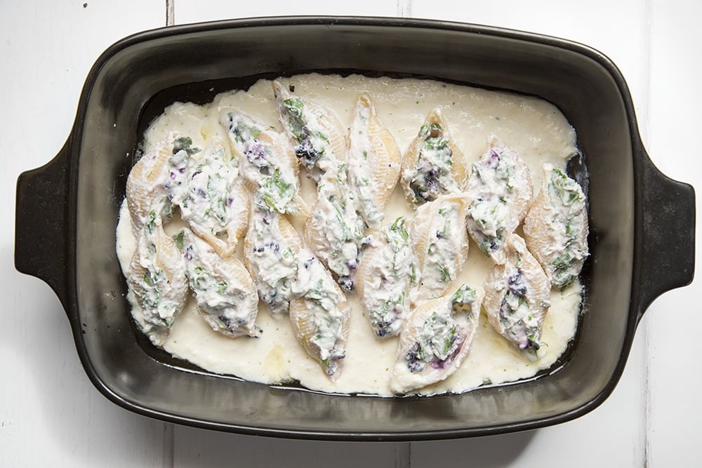 The ricotta blackberry stuffed giant pasta shells are added to the dish