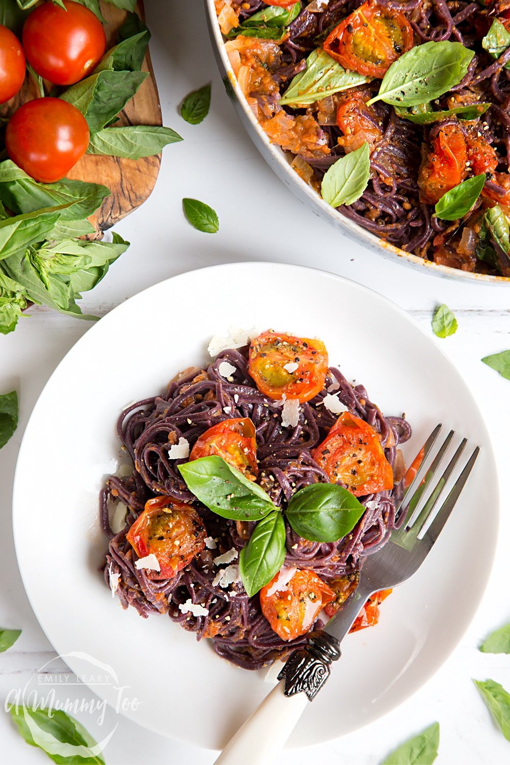 Top the black spaghetti with roasted tomatoes with shavings of vegan cheese, serve and enjoy!