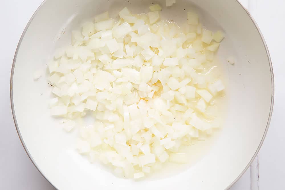 Preparing the garlic and onion for the pasta dish