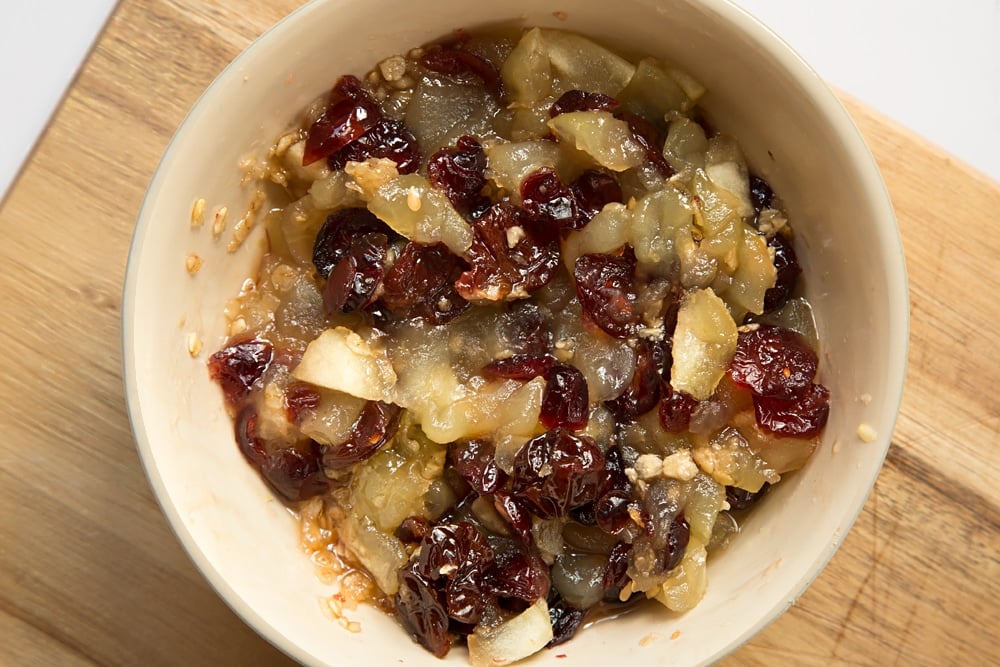 The fruits are softened in a microwave to make the filling for this apple cherry granola crumble