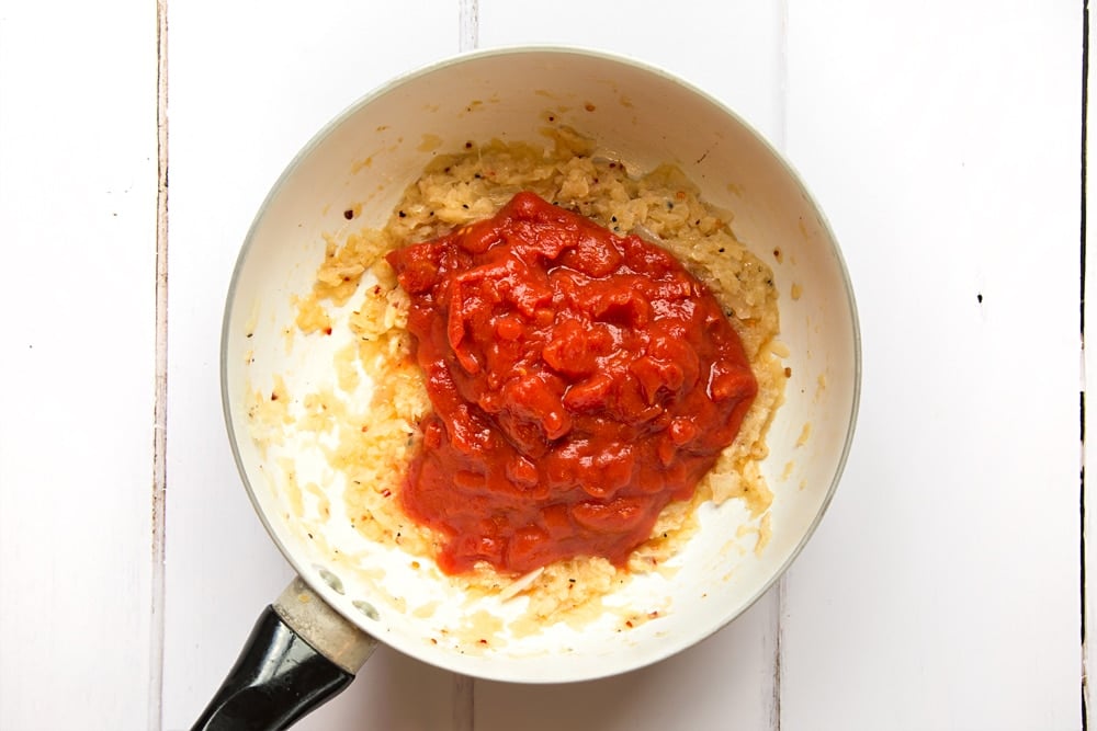 Tomatoes are added to the pasta sauce and simmered